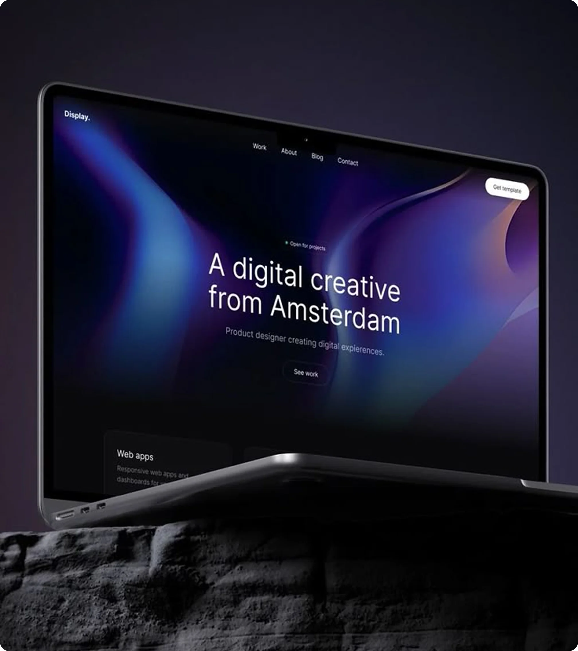 Website design showing laptop with dark themed website